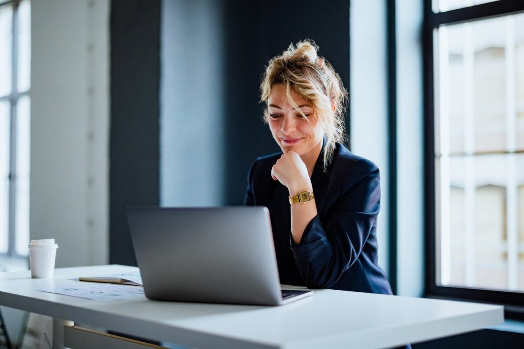 Person working at a laptop desk.
