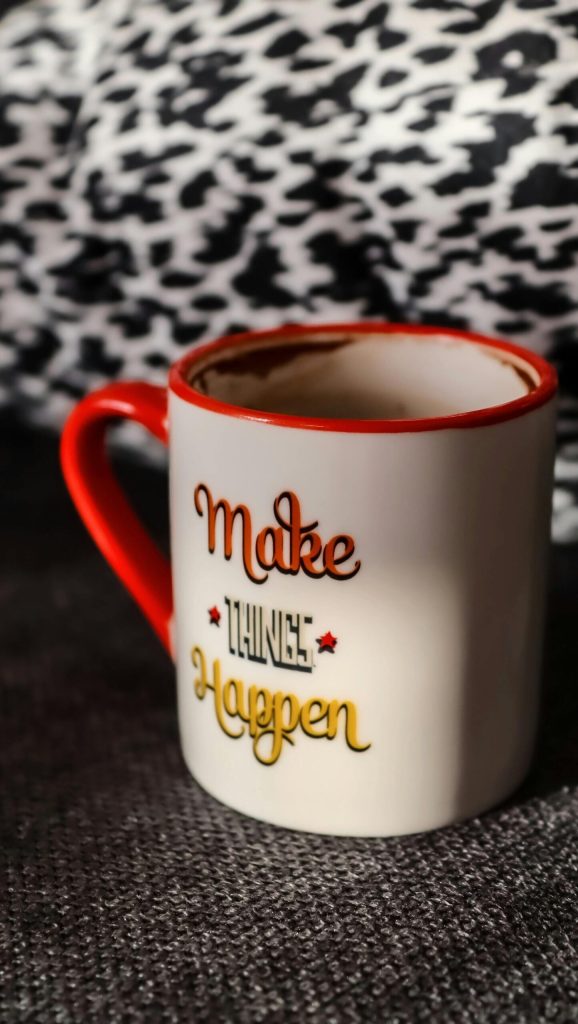 Coffee mug with motivational text.